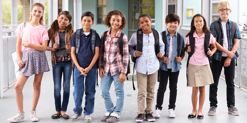 Group of elementary school kids hanging out at school