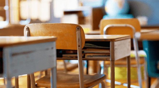 Empty classroom chairs and desks