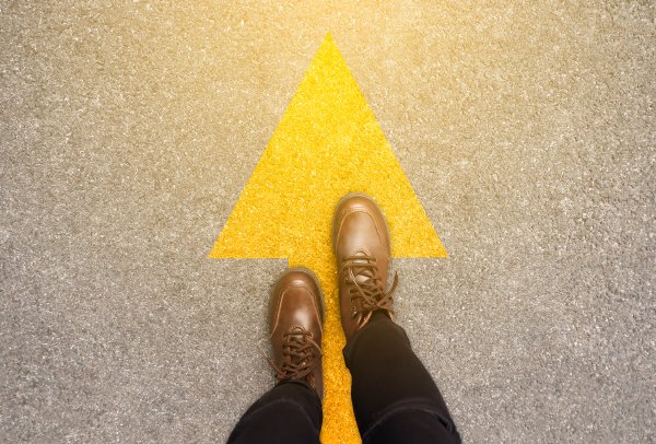 Image of Feet and arrows on road background in starting line beginning idea