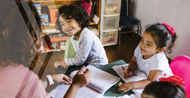 Image of a teacher with three elementary grade students