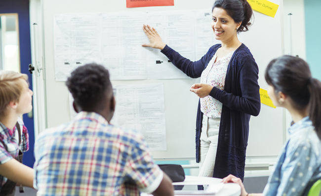 Image of student looking at teacher showing documents on whiteboard